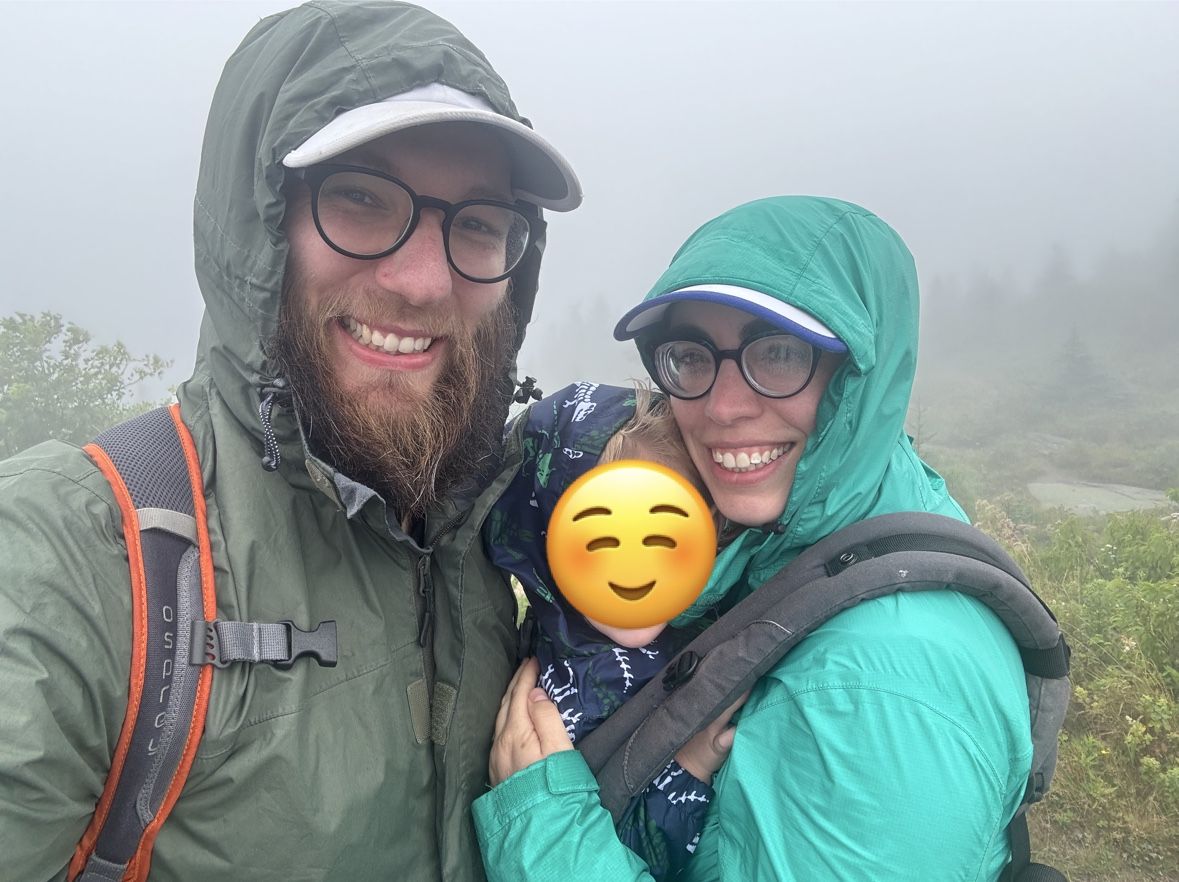 A picture of my family in raincoats, my son's face blocked out by an emoji.