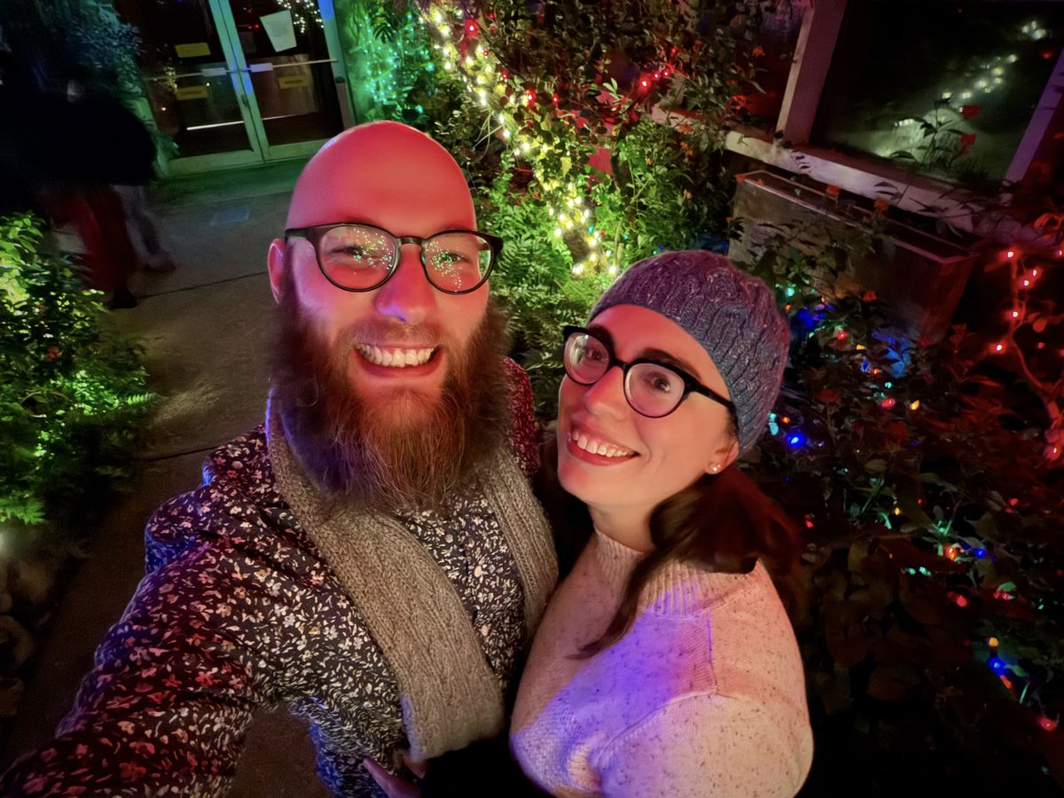 My wife and I in a holiday lit space