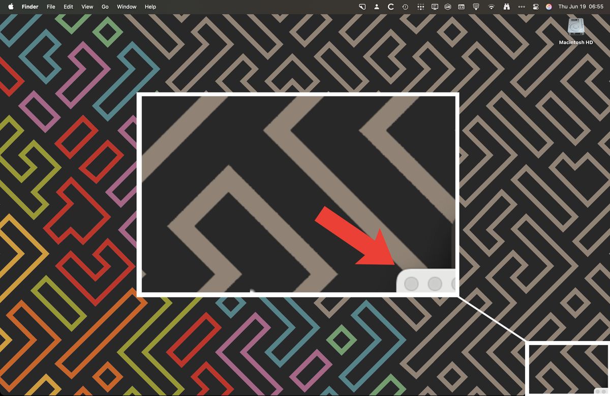 A screenshot of my desktop, with a zoomed in box of the bottom right corner. In the box there is a red arrow pointing to the small corner of a hidden window just barely in the box