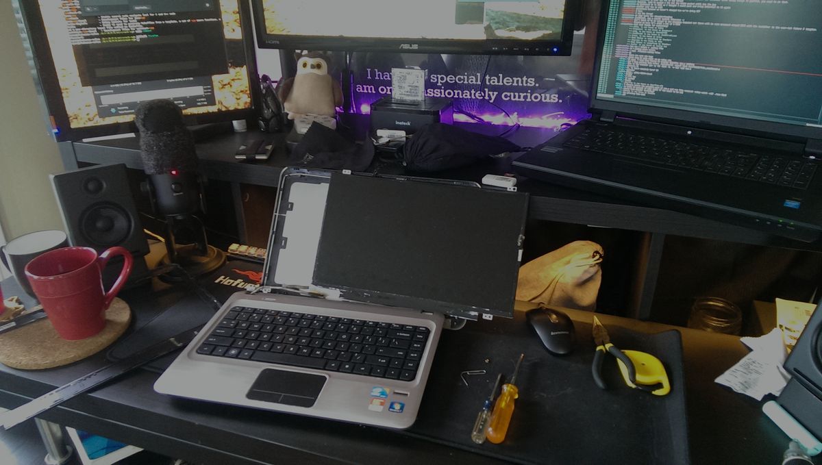 My desk in a mess with a de-screened laptop