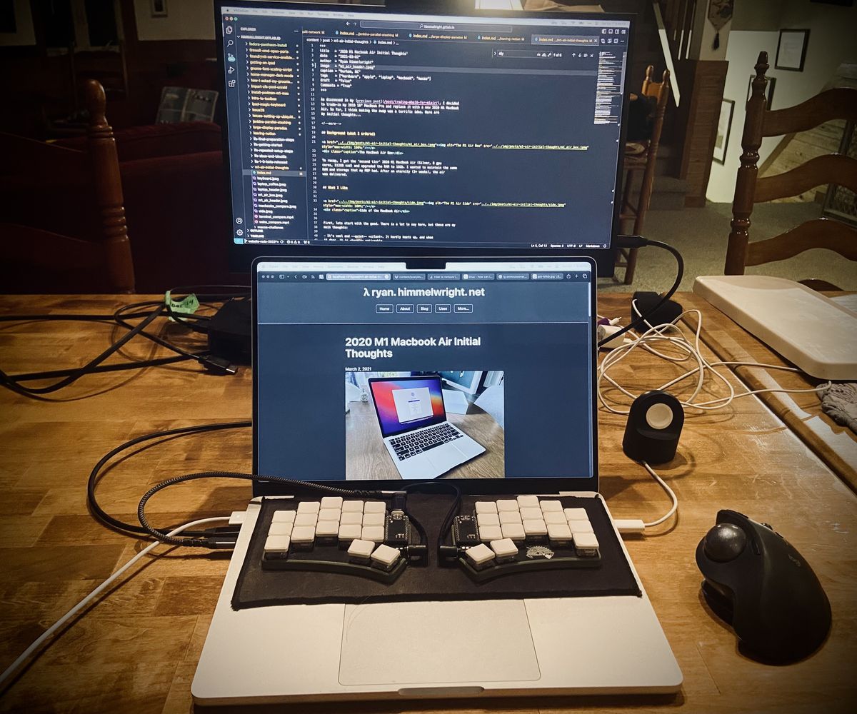 A laptop with split keyboard, ergo mouth, and portable monitor.