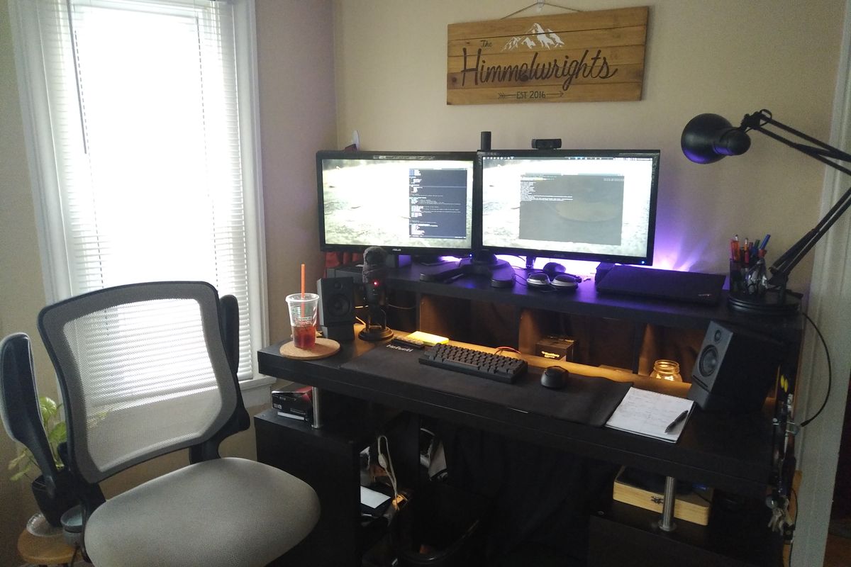 A picture of the desk and monitors with chair