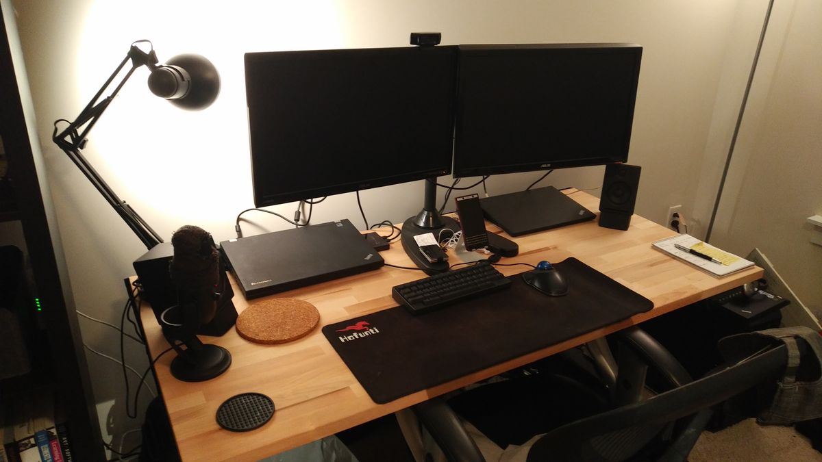 A desk with two monitors on it