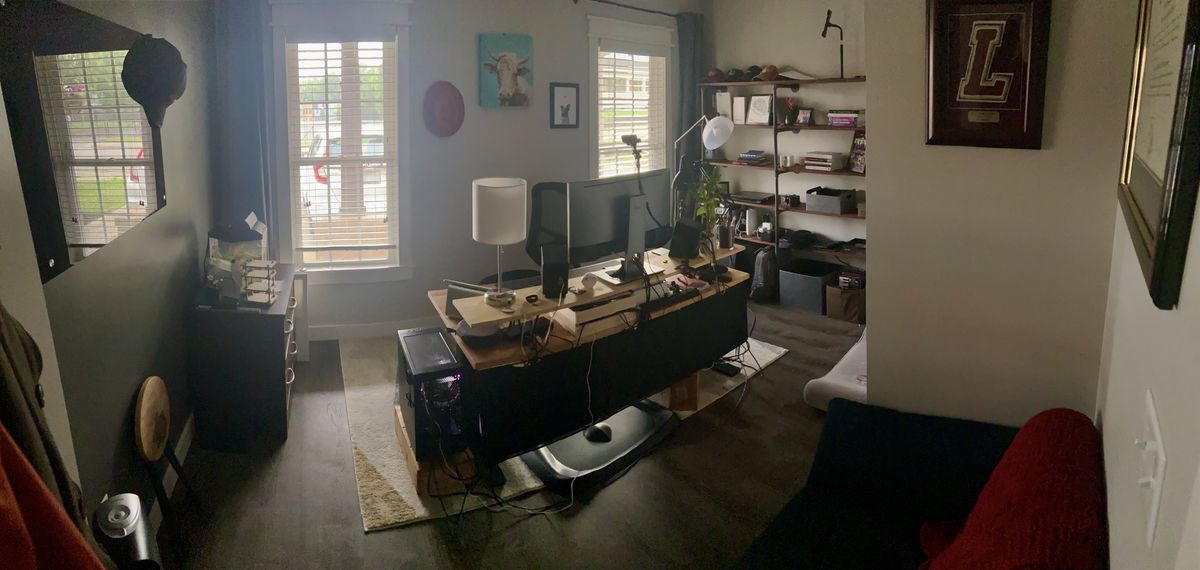 A wide angle view of a home office with the desk in the center facing the camera