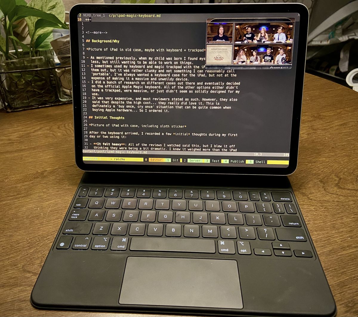An 11 inch ipad Pro in the magic keyboard on a table, with tmux and neovim opened, and a small pop out window of Critical Role playing in the corner.